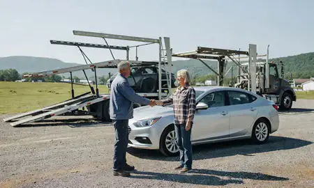 Vehicle owner beside their delivered car in Castleton Four Corners, Vermont, United States