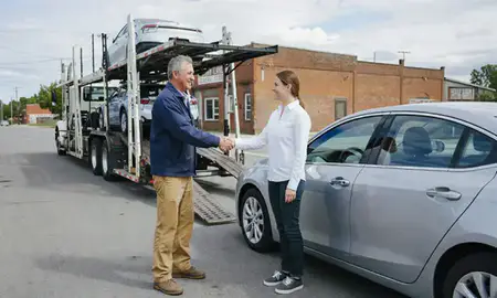 Vehicle owner beside their delivered car in Derby Line, Vermont, United States