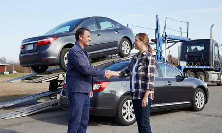Vehicle owner beside their delivered car in Enosburg Falls, Vermont, United States