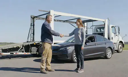 Vehicle owner beside their delivered car in Essex Junction, Vermont, United States