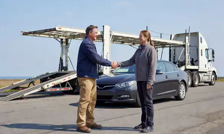 Vehicle owner beside their delivered car in Island Pond, Vermont, United States