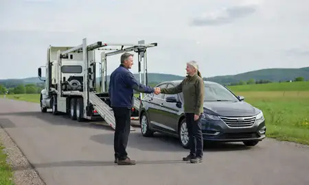 Vehicle owner beside their delivered car in Lyndonville, Vermont, United States