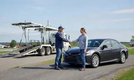 Vehicle owner beside their delivered car in Morrisville, Vermont, United States