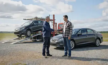 Vehicle owner beside their delivered car in Orleans, Vermont, United States