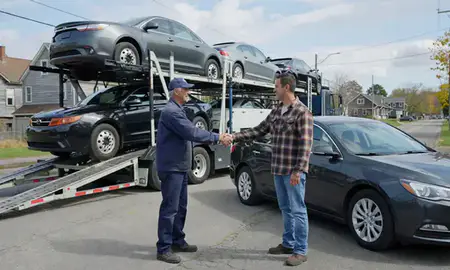 Vehicle owner beside their delivered car in Saxtons River, Vermont, United States