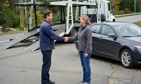 Vehicle owner beside their delivered car in South Barre, Vermont, United States