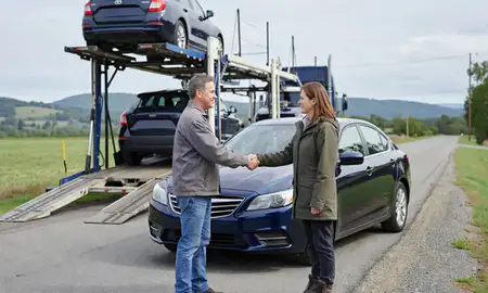Vehicle owner beside their delivered car in Underhill Flats, Vermont, United States