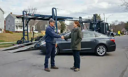 Vehicle owner beside their delivered car in West Brattleboro, Vermont, United States
