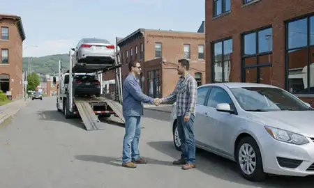 Vehicle owner beside their delivered car in Winooski, Vermont, United States