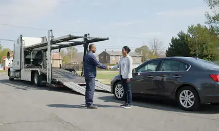 Vehicle owner beside their delivered car in Richmond, Virginia, United States