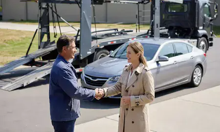 Vehicle owner beside their delivered car in Washington, United States