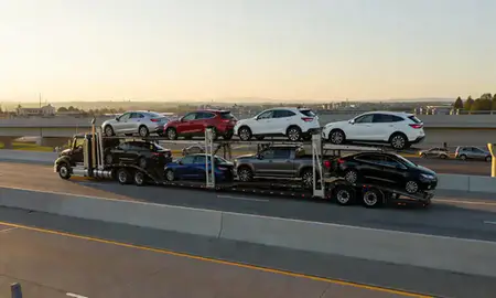 Car transporter with the Auburn, Washington, United States skyline behind it