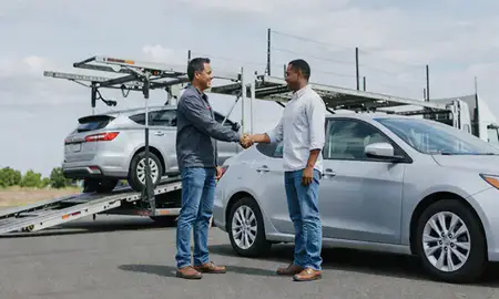 Vehicle owner beside their delivered car in Longview, Washington, United States