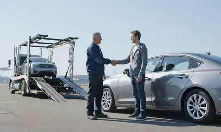 Vehicle owner beside their delivered car in Tacoma, Washington, United States