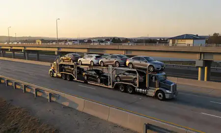 Car transporter with the Cross Lanes, West Virginia, United States skyline behind it