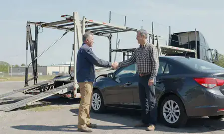 Vehicle owner beside their delivered car in Nitro, West Virginia, United States