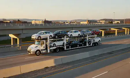 Car transporter with the Princeton, West Virginia, United States skyline behind it