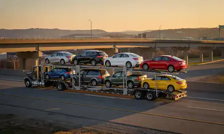 Car transporter with the Wheeling, West Virginia, United States skyline behind it