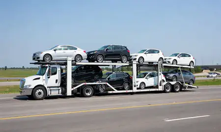 Multi-level car carrier on the highway to Janesville, Wisconsin, United States