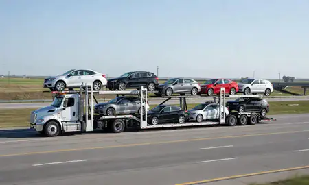 Multi-level car carrier on the highway to Oshkosh, Wisconsin, United States