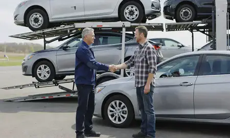 Vehicle owner beside their delivered car in Oshkosh, Wisconsin, United States