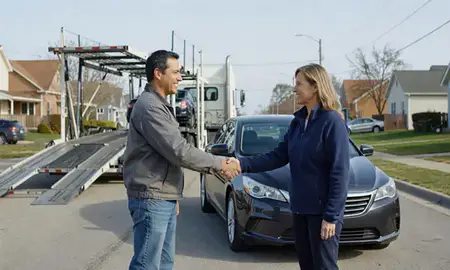 Vehicle owner beside their delivered car in West Allis, Wisconsin, United States