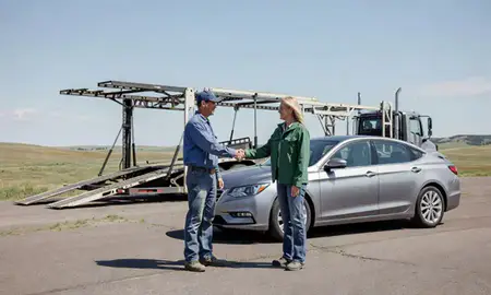 Vehicle owner beside their delivered car in Wyoming, United States