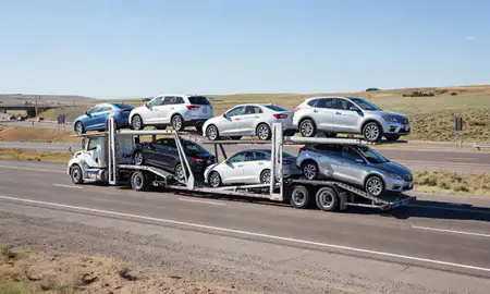 Multi-level car carrier on the highway to Bar Nunn, Wyoming, United States