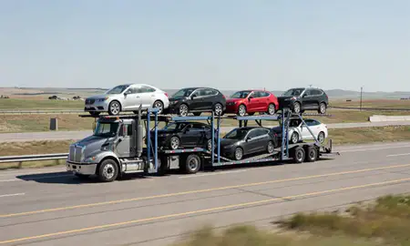 Multi-level car carrier on the highway to Buffalo, Wyoming, United States