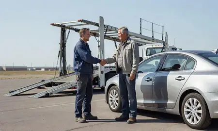 Vehicle owner beside their delivered car in Buffalo, Wyoming, United States
