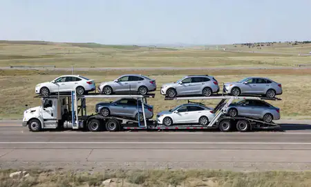 Multi-level car carrier on the highway to Casper, Wyoming, United States