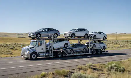 Multi-level car carrier on the highway to Cody, Wyoming, United States