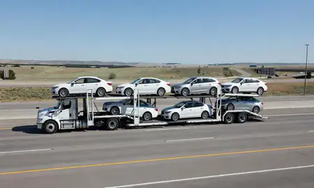 Multi-level car carrier on the highway to Evanston, Wyoming, United States