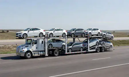 Multi-level car carrier on the highway to Evansville, Wyoming, United States
