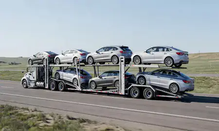Multi-level car carrier on the highway to Fox Farm-College, Wyoming, United States