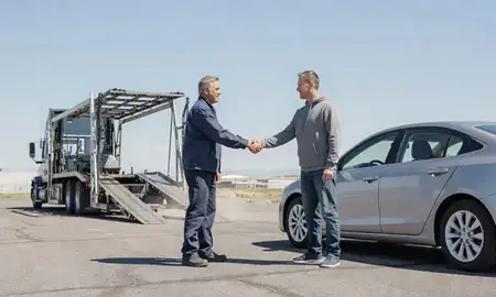 Vehicle owner beside their delivered car in Kemmerer, Wyoming, United States