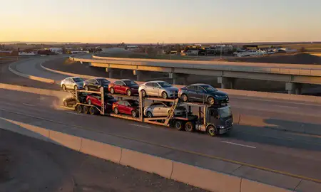 Car transporter with the Kemmerer, Wyoming, United States skyline behind it