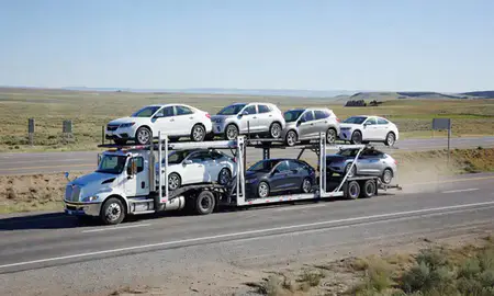 Multi-level car carrier on the highway to Lander, Wyoming, United States