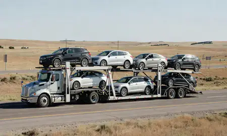 Multi-level car carrier on the highway to Laramie, Wyoming, United States
