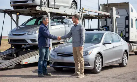 Vehicle owner beside their delivered car in Mills, Wyoming, United States