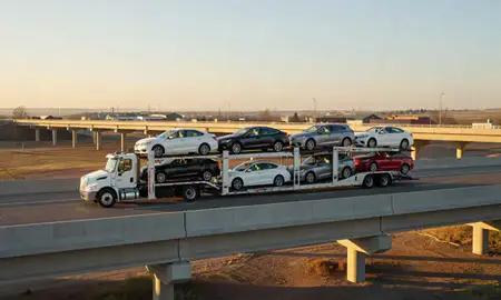 Car transporter with the Mills, Wyoming, United States skyline behind it