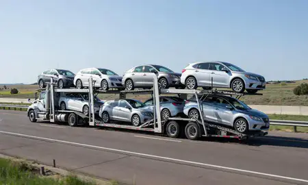 Multi-level car carrier on the highway to Ranchettes, Wyoming, United States