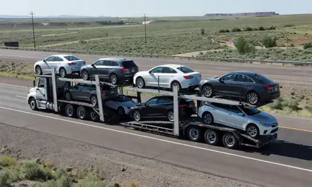 Multi-level car carrier on the highway to Rawlins, Wyoming, United States