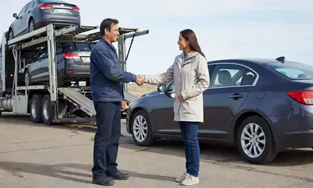 Vehicle owner beside their delivered car in Rawlins, Wyoming, United States