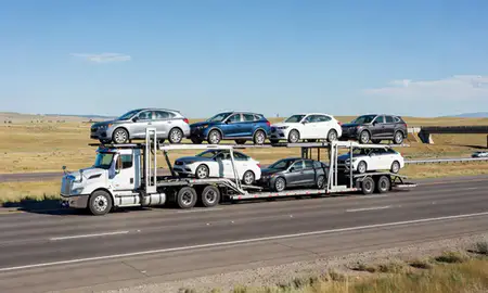 Multi-level car carrier on the highway to Sheridan, Wyoming, United States