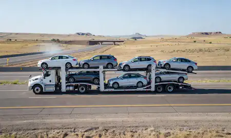 Multi-level car carrier on the highway to Thermopolis, Wyoming, United States