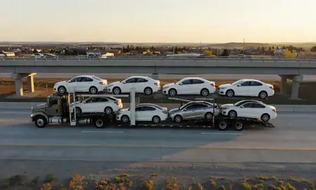 Car transporter with the Torrington, Wyoming, United States skyline behind it