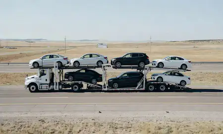 Multi-level car carrier on the highway to Wheatland, Wyoming, United States