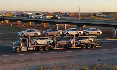 Car transporter with the Worland, Wyoming, United States skyline behind it